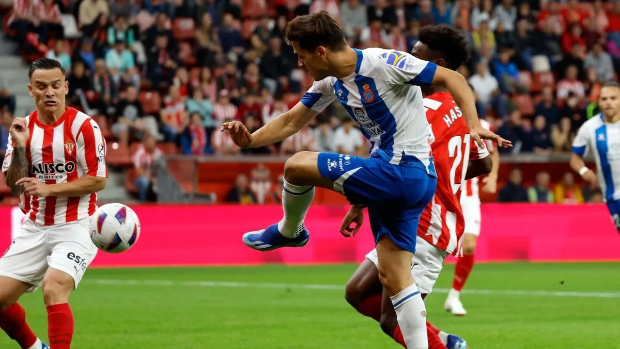 Photograph of soccer players contesting the ball during a match in a packed stadium