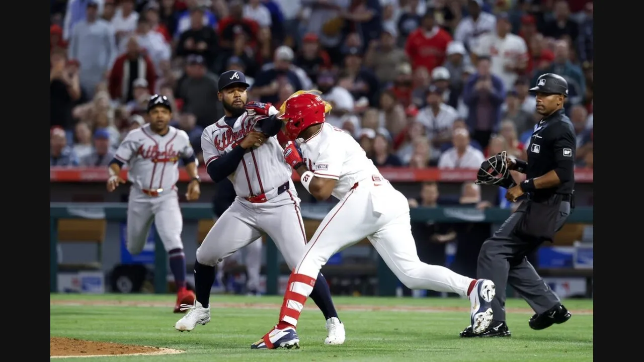 Photograph of baseball players contesting a play at a base during a night game, with the umpire watching